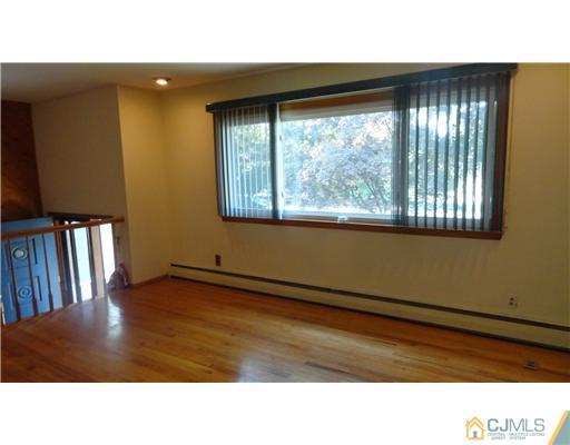 740 Old Raritan Road Edison, NJ 08820 - Photo 5 of 24 a black and white photo of a living room