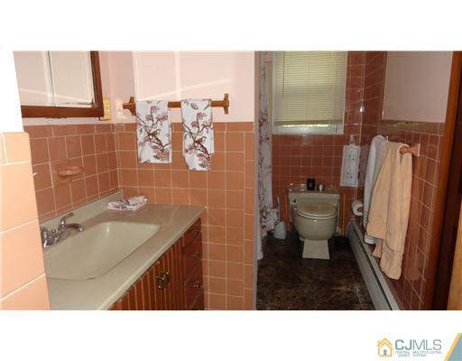 740 Old Raritan Road Edison, NJ 08820 - Photo 7 of 24 a bathroom with a sink toilet and shower