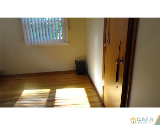 740 Old Raritan Road Edison, NJ 08820 - Photo 9 of 24 a open living room with a couch and wooden floor