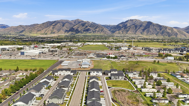 1173 West 1870 South Logan, UT 84321 - Photo 30 of 33 Aerial perspective showcasing a developing residential area with rows of detached homes and a backdrop of mountains
