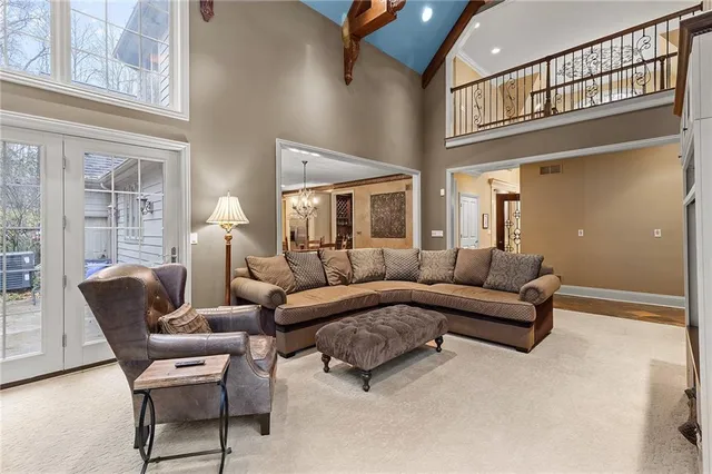 a living room with furniture and a chandelier