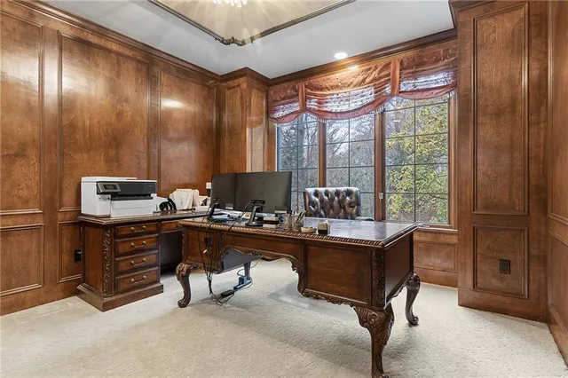 a view of a workspace with furniture and a window