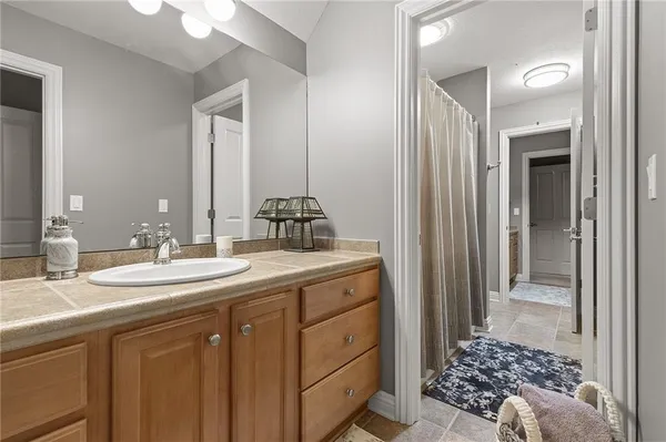 a en suite bathroom with a sink a mirror and a shower
