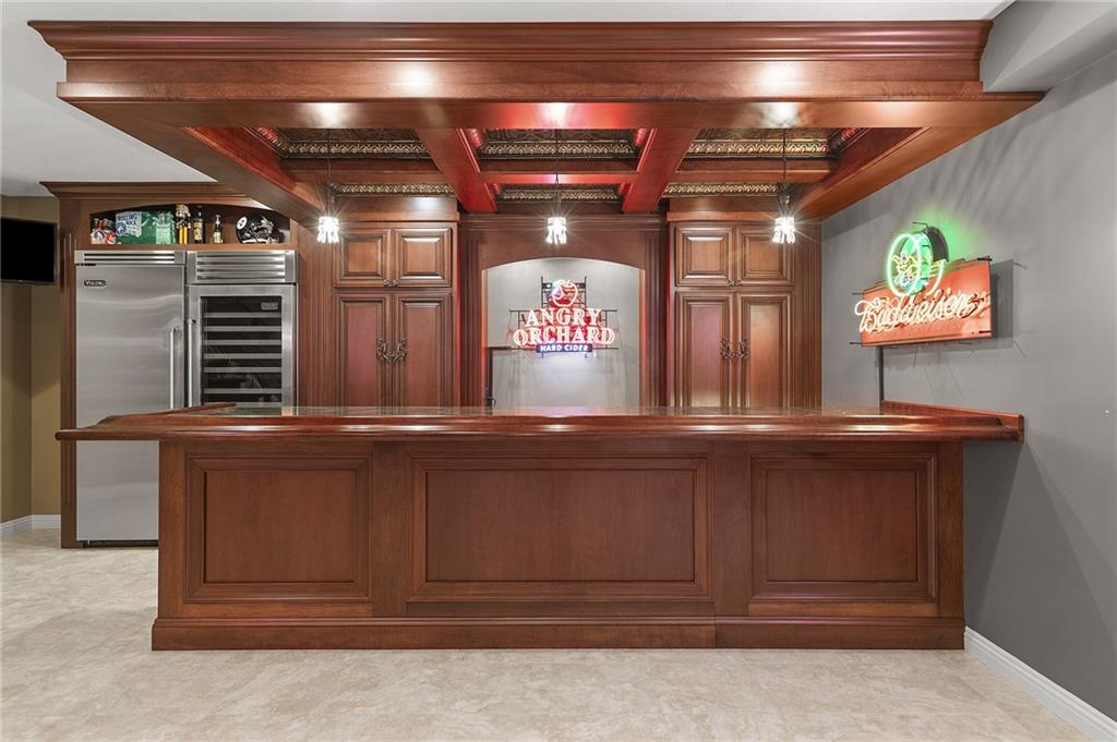 1607 Fieldstone Lane Sewickley, PA 15143 - Photo 34 of 48 An entertainers dream bar! solid wood, with thick coffered wood ceiling detail, inlayed mirror and lighting throughtout.