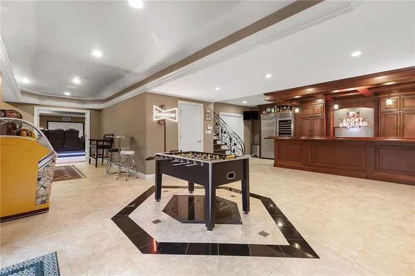 a living room with furniture a table and kitchen view