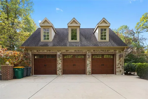 a front view of a house with yard and garage