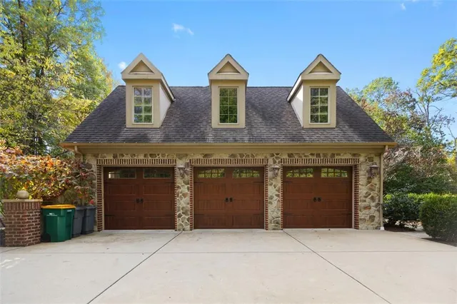 a front view of a house with yard and garage