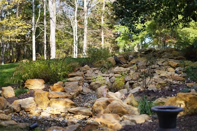 a view of a house with a yard and garden