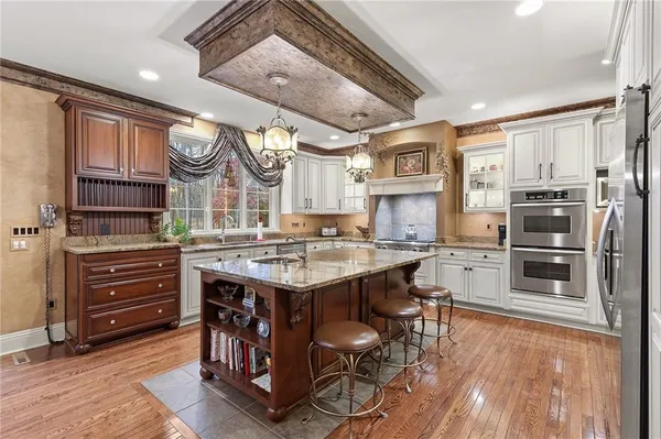 a kitchen with a sink stainless steel appliances and cabinets