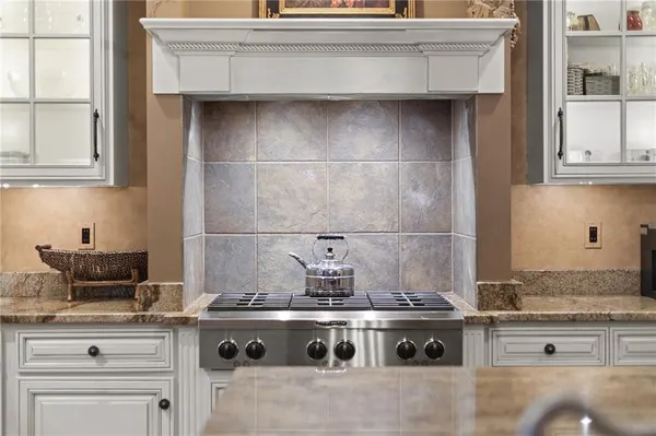 a stove top oven sitting inside of a kitchen