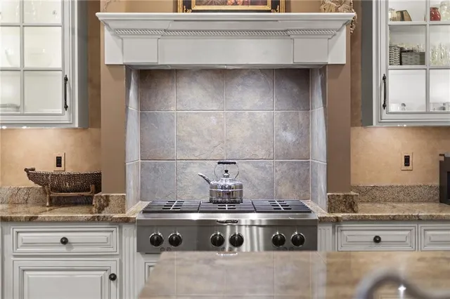 a stove top oven sitting inside of a kitchen
