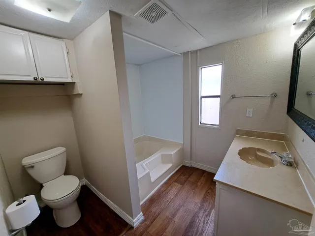 a bathroom with a sink a toilet and bathtub