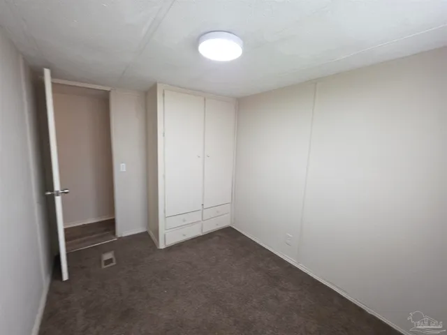 a view of an empty room and a window