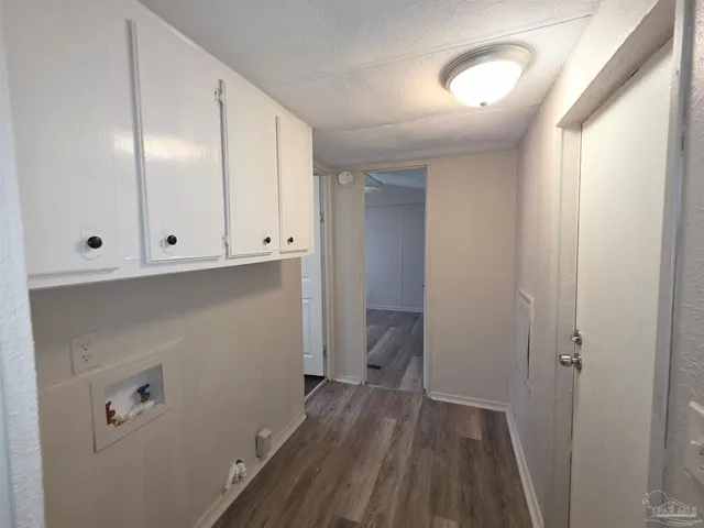 a view of hallway with wooden floor