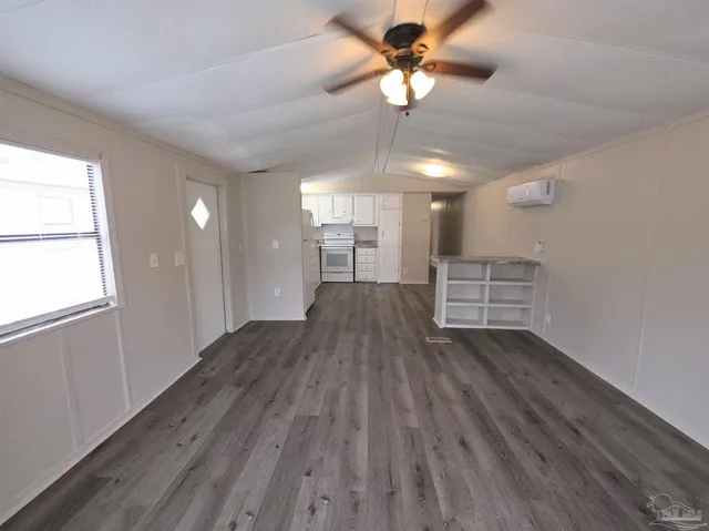 a view of a livingroom with a hardwood floor and a ceiling fan