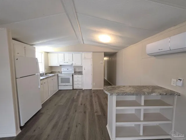 a kitchen with refrigerator and cabinets