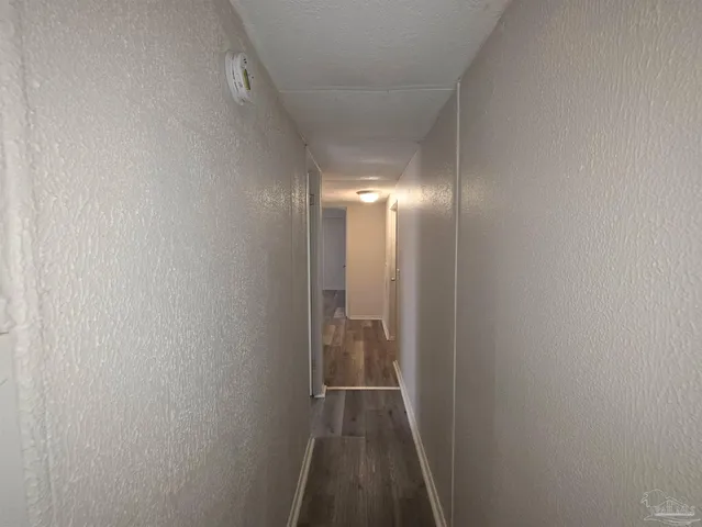 a view of hallway with wooden floor