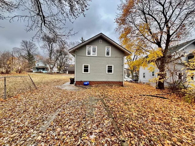 a view of a house with a yard covered in snow