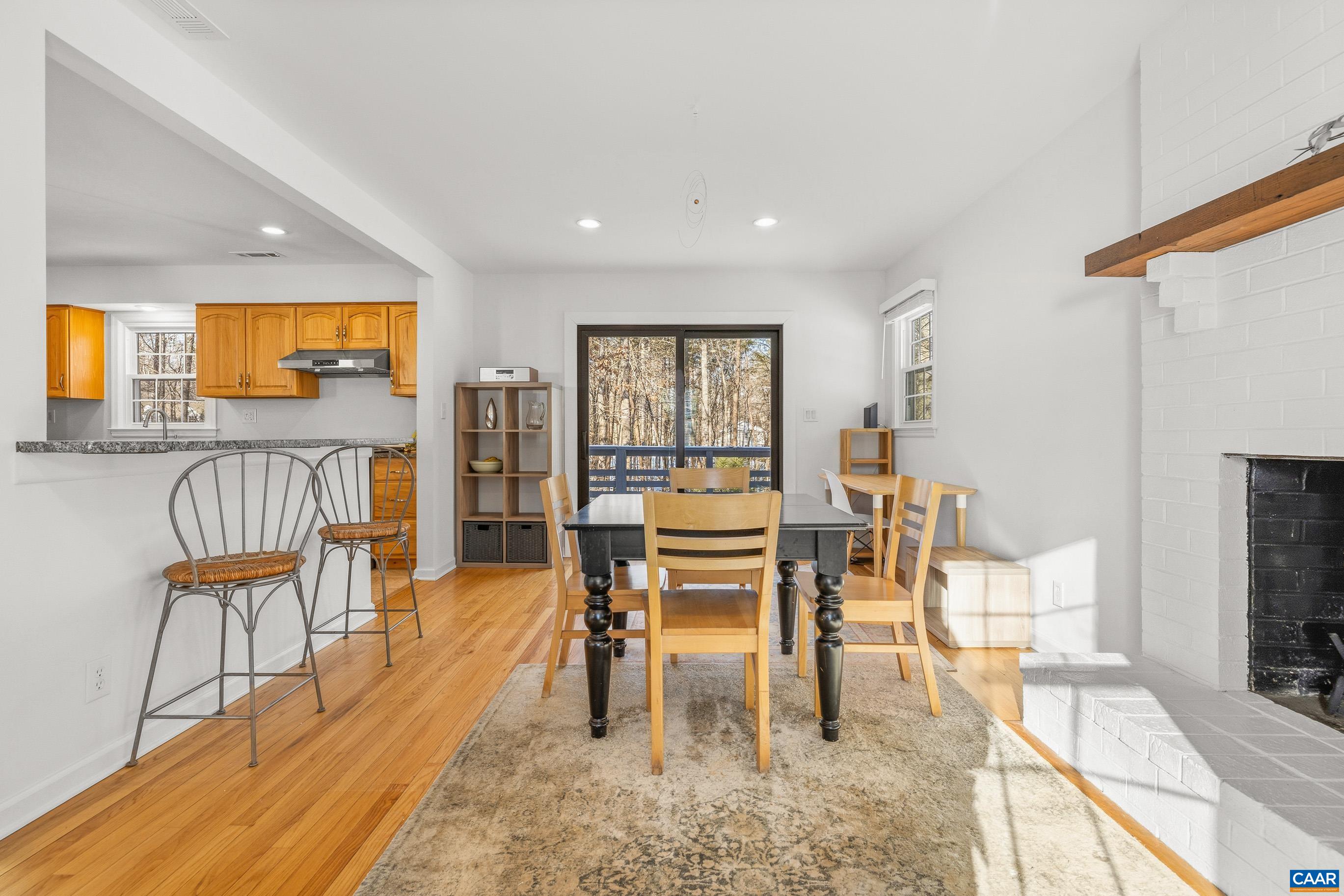 1284 Tilman Road Charlottesville, VA 22901 - Photo 11 of 36 a dining room with furniture and a flat screen tv