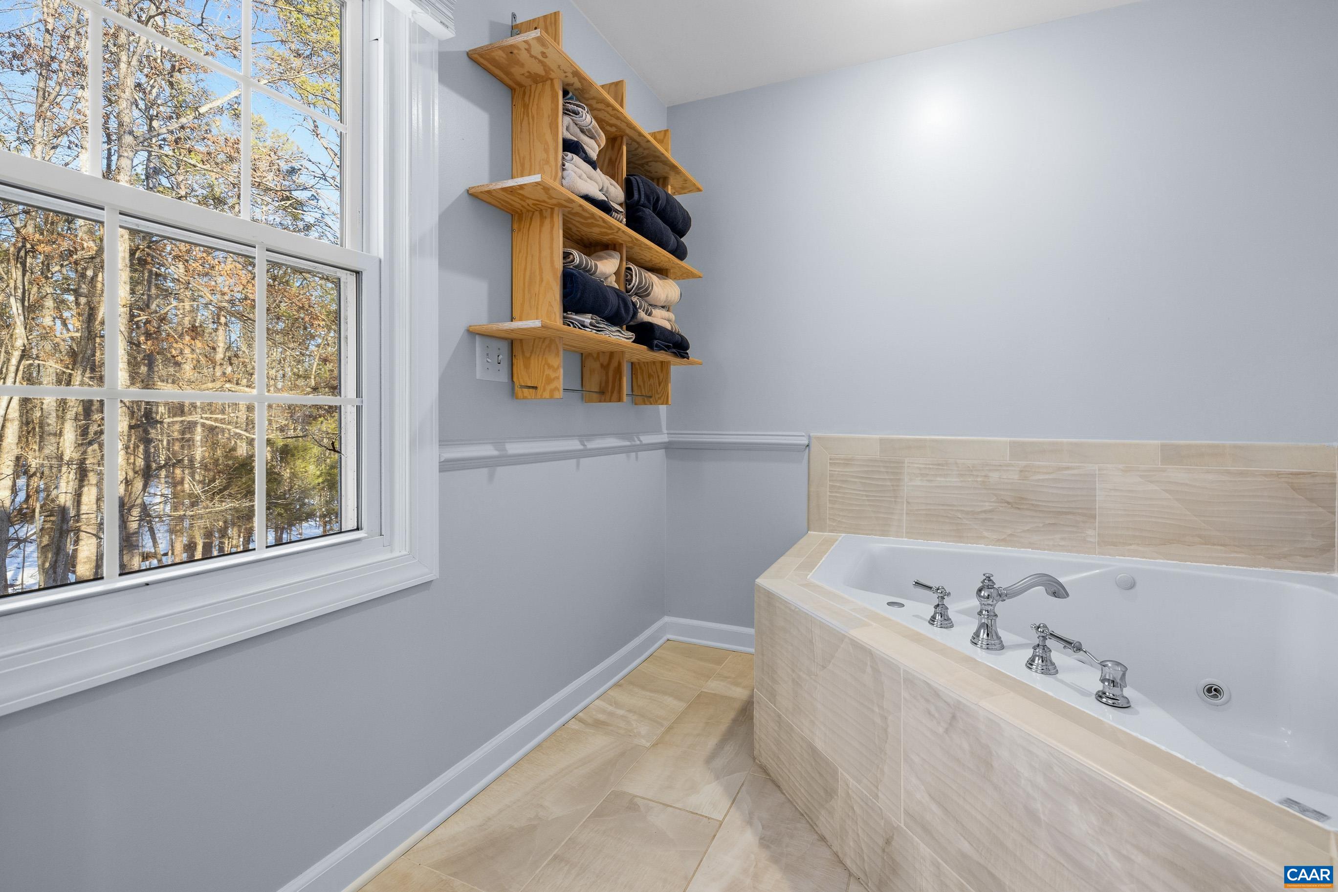 1284 Tilman Road Charlottesville, VA 22901 - Photo 22 of 36 a bathroom with a bathtub and a window
