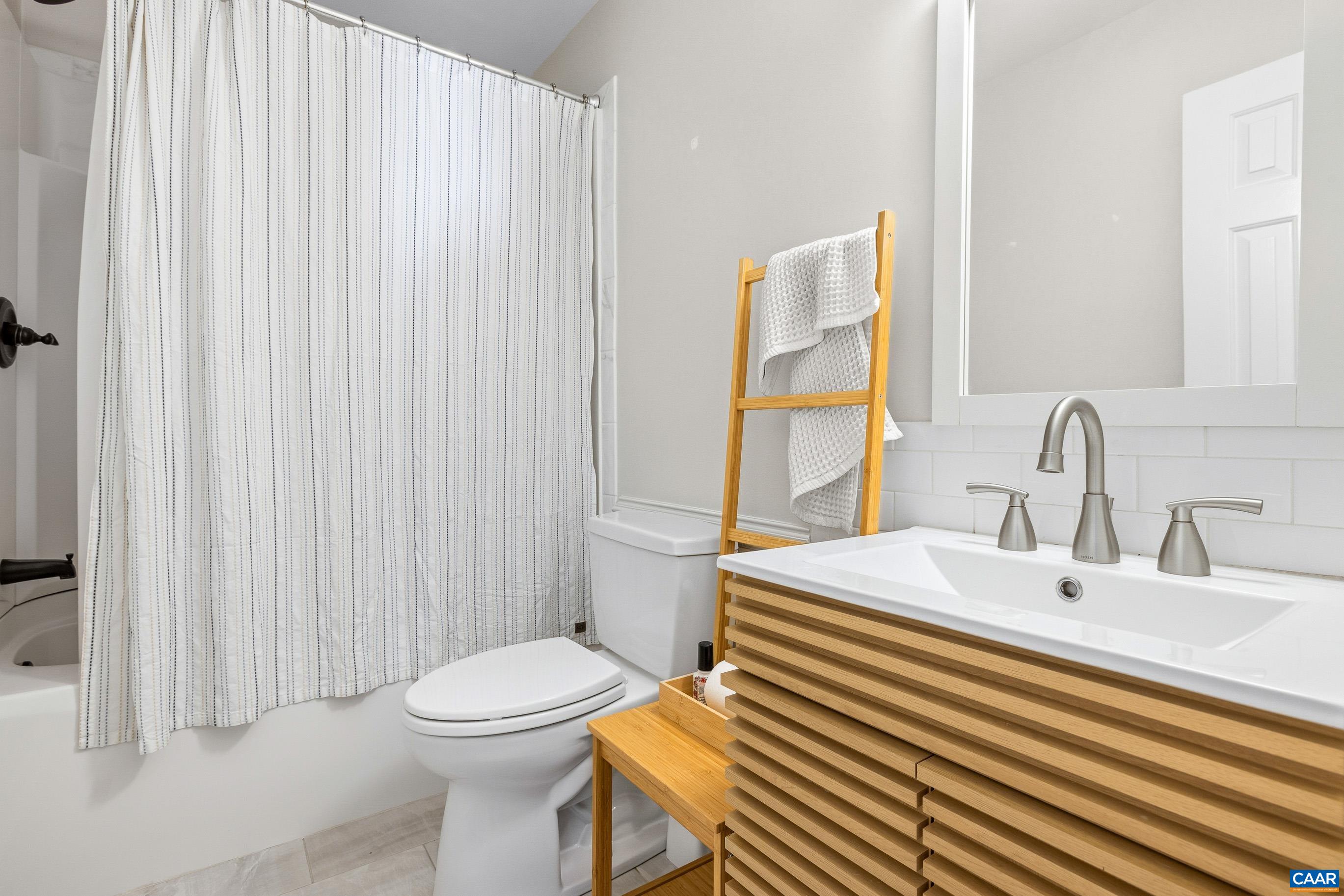 1284 Tilman Road Charlottesville, VA 22901 - Photo 25 of 36 a bathroom with a sink a toilet and shower curtain