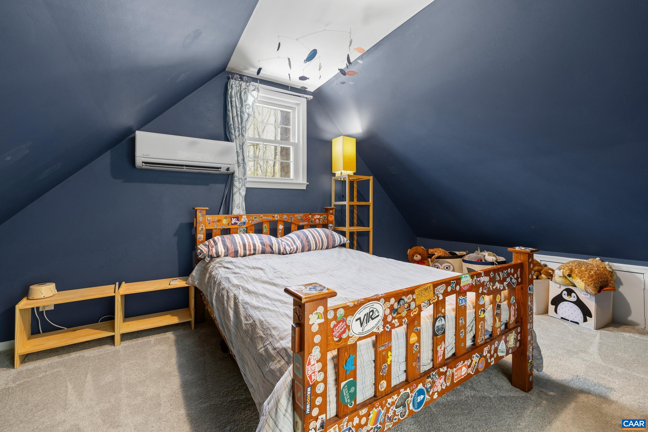 1284 Tilman Road Charlottesville, VA 22901 - Photo 32 of 36 a bedroom with a bed and a chandelier