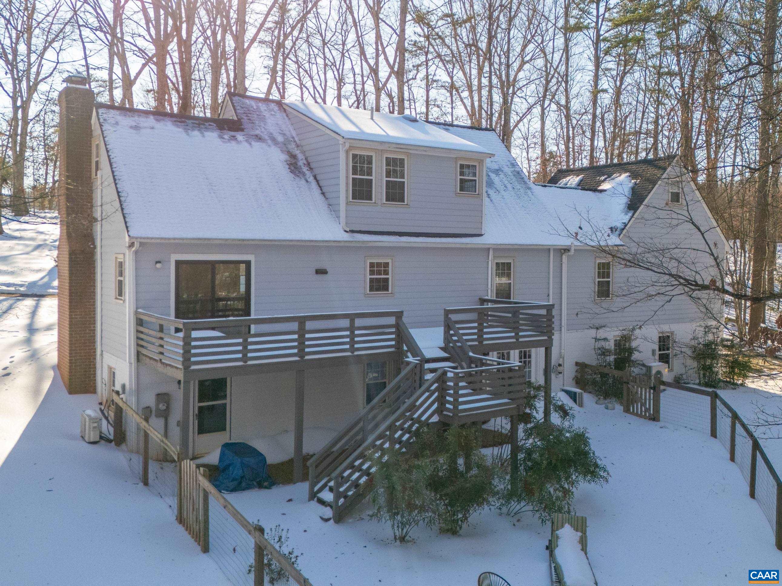 1284 Tilman Road Charlottesville, VA 22901 - Photo 35 of 36 a view of a patio with table and chairs with wooden floor and fence