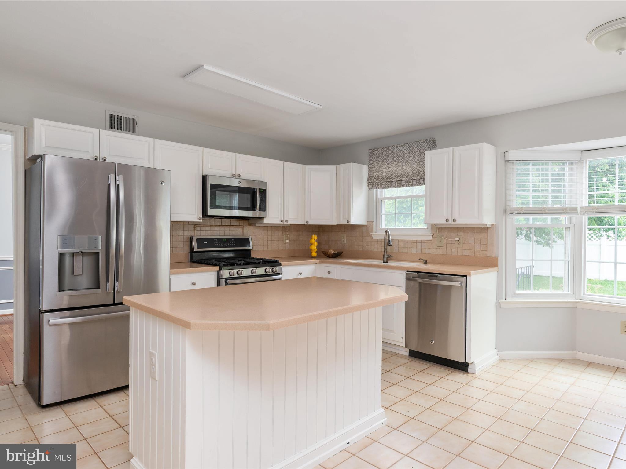 2324 Nantucket Drive Crofton, MD 21114 - Photo 16 of 63 a kitchen with stainless steel appliances granite countertop a refrigerator a stove a sink a microwave and white cabinets