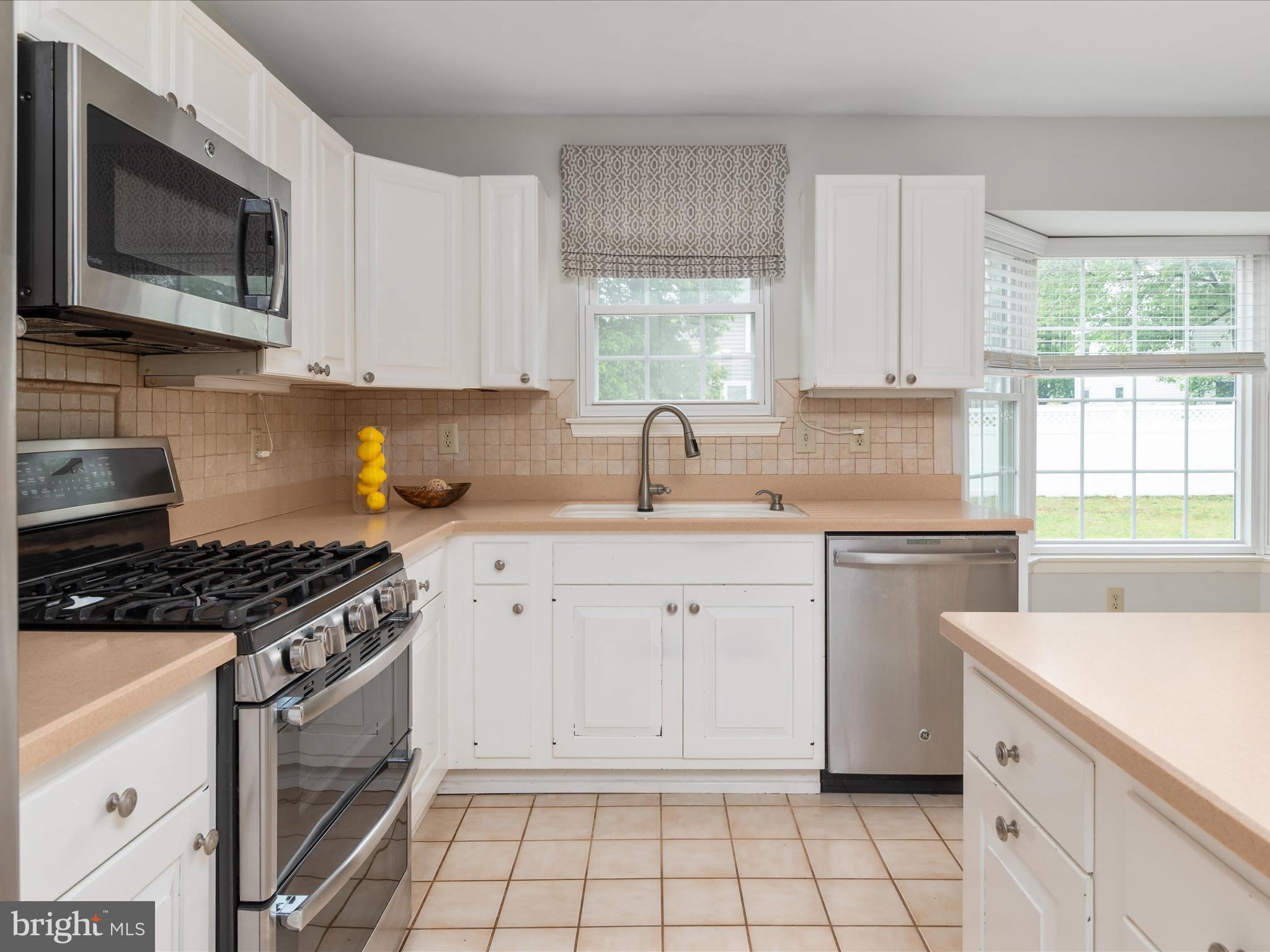 2324 Nantucket Drive Crofton, MD 21114 - Photo 17 of 63 a kitchen with cabinets appliances a sink and a window