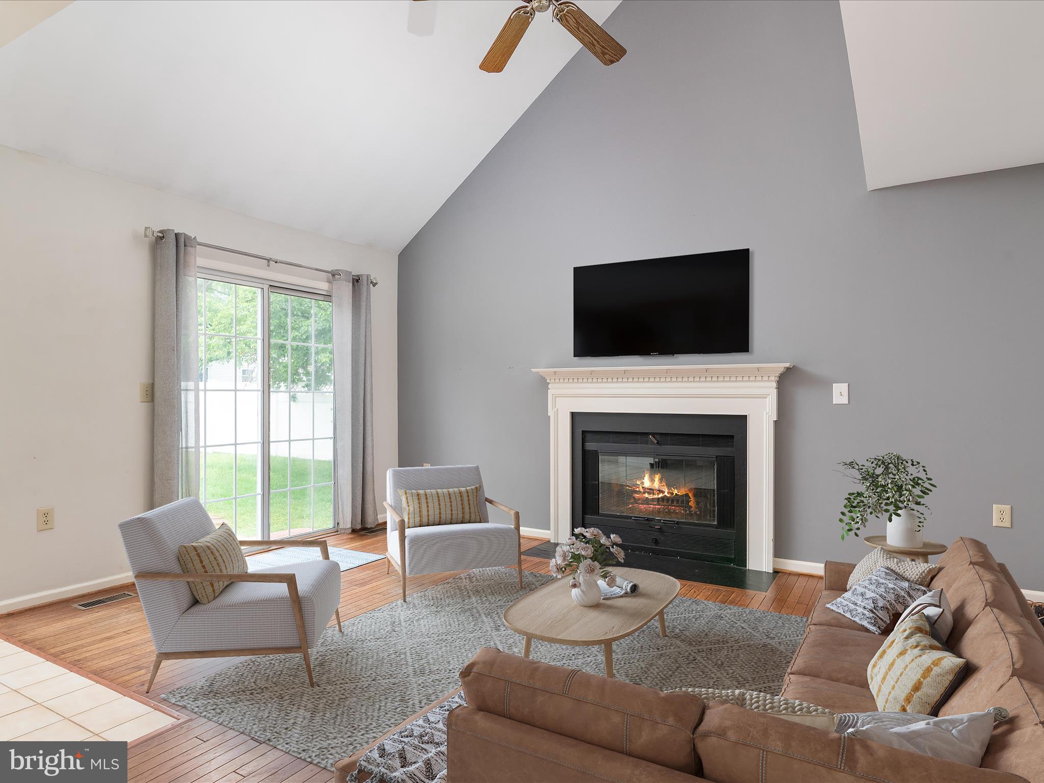 2324 Nantucket Drive Crofton, MD 21114 - Photo 19 of 63 a living room with furniture a fireplace and a flat screen tv