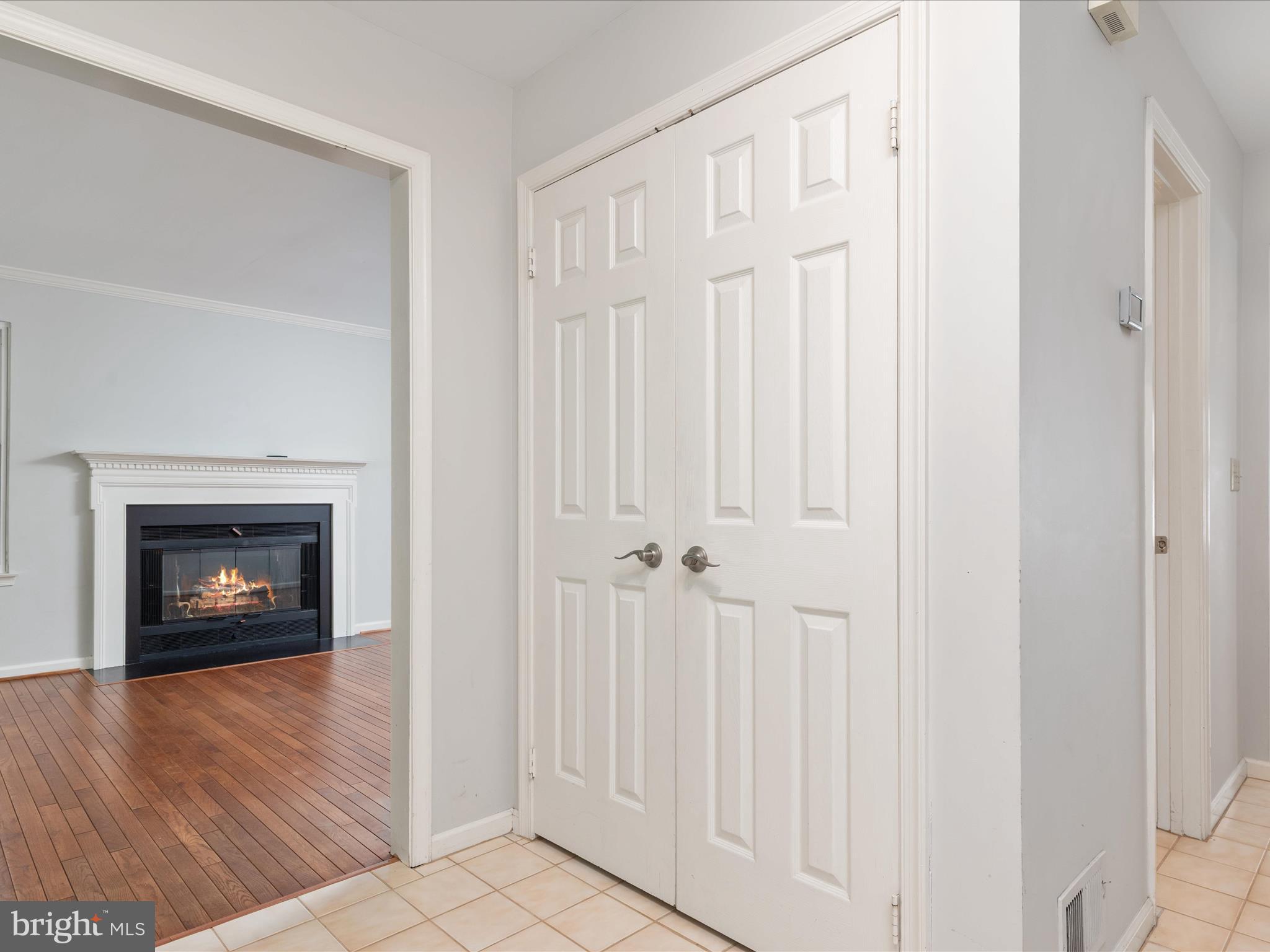 2324 Nantucket Drive Crofton, MD 21114 - Photo 7 of 63 a view of an empty room with wooden floor a fireplace and a window