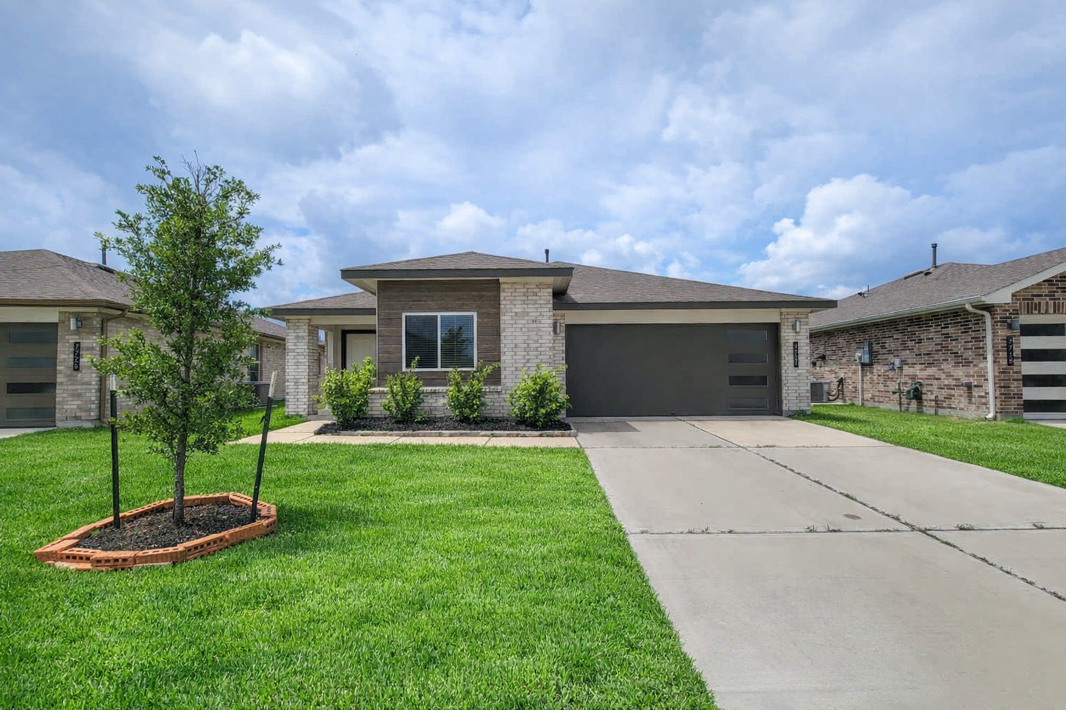 7722 Caldwell Crk Way Rosharon, TX 77583 - Photo 1 of 40 This is a modern, single-story brick house with a well-maintained lawn, a young tree, and a spacious driveway leading to a two-car garage.