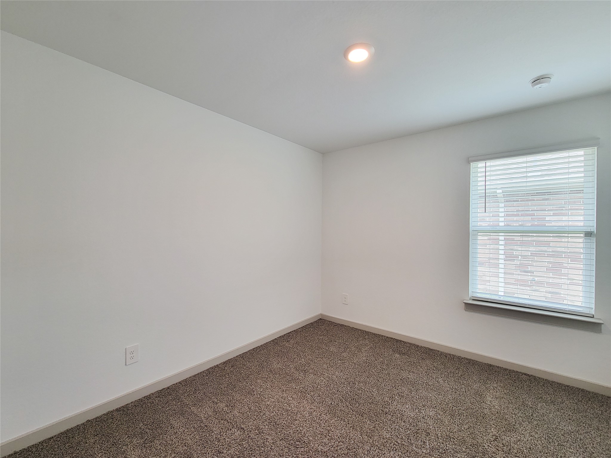 7722 Caldwell Crk Way Rosharon, TX 77583 - Photo 19 of 40 This is a cozy, well-lit room with neutral-colored walls and carpet flooring. It features a window with blinds, allowing natural light to fill the space. Ideal for a bedroom or office.