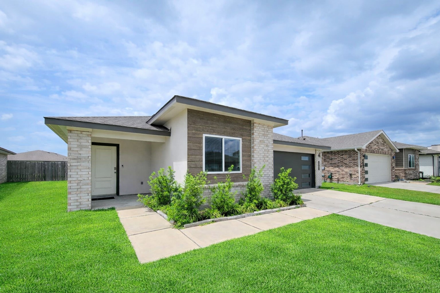 7722 Caldwell Crk Way Rosharon, TX 77583 - Photo 2 of 40 This modern single-story home features a clean façade with a mix of brick and siding. It has a neatly landscaped front yard, a covered entryway, and an attached garage. Located in a quiet neighborhood, it offers a welcoming atmosphere.