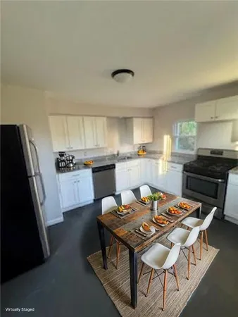 a kitchen with a dining table and chairs