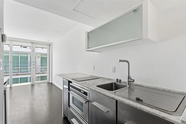 a kitchen with a sink and a stove top oven