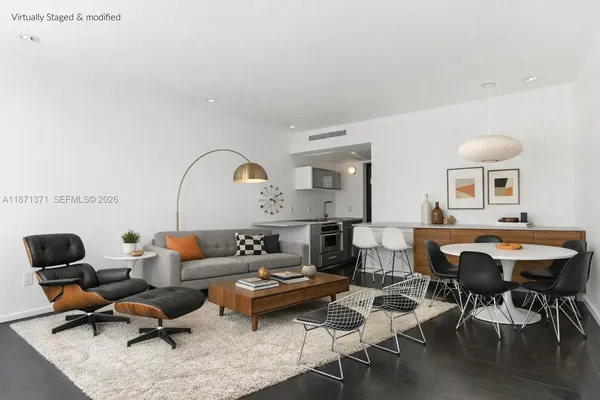 a living room with furniture a rug and a table
