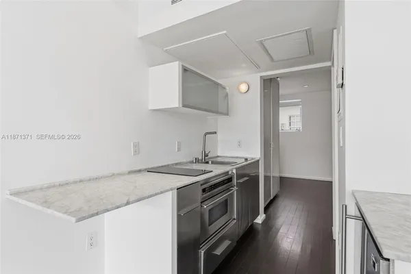a kitchen that has a sink and a stove