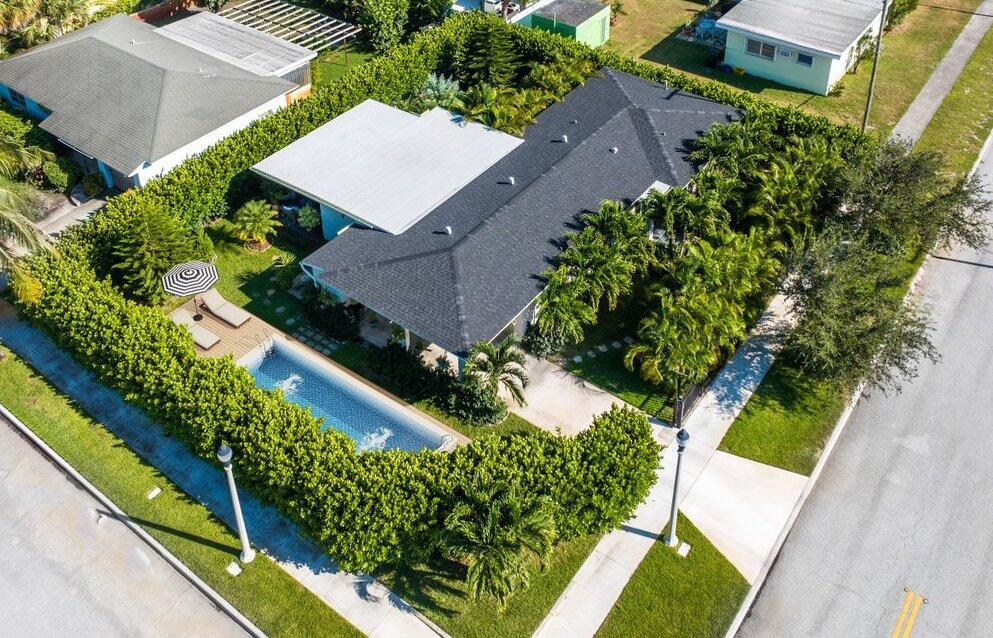an aerial view of a residential houses with greenery space