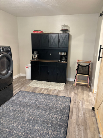1324 West Raintree Drive, Unit 44 Price, UT 84501 - Photo 12 of 25 Laundry area featuring wood-finish flooring and light-toned walls