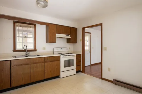 a kitchen with a sink stove and cabinets