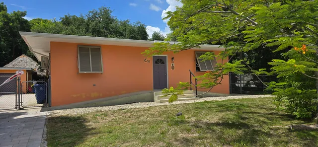 a backyard of a house with table and chairs