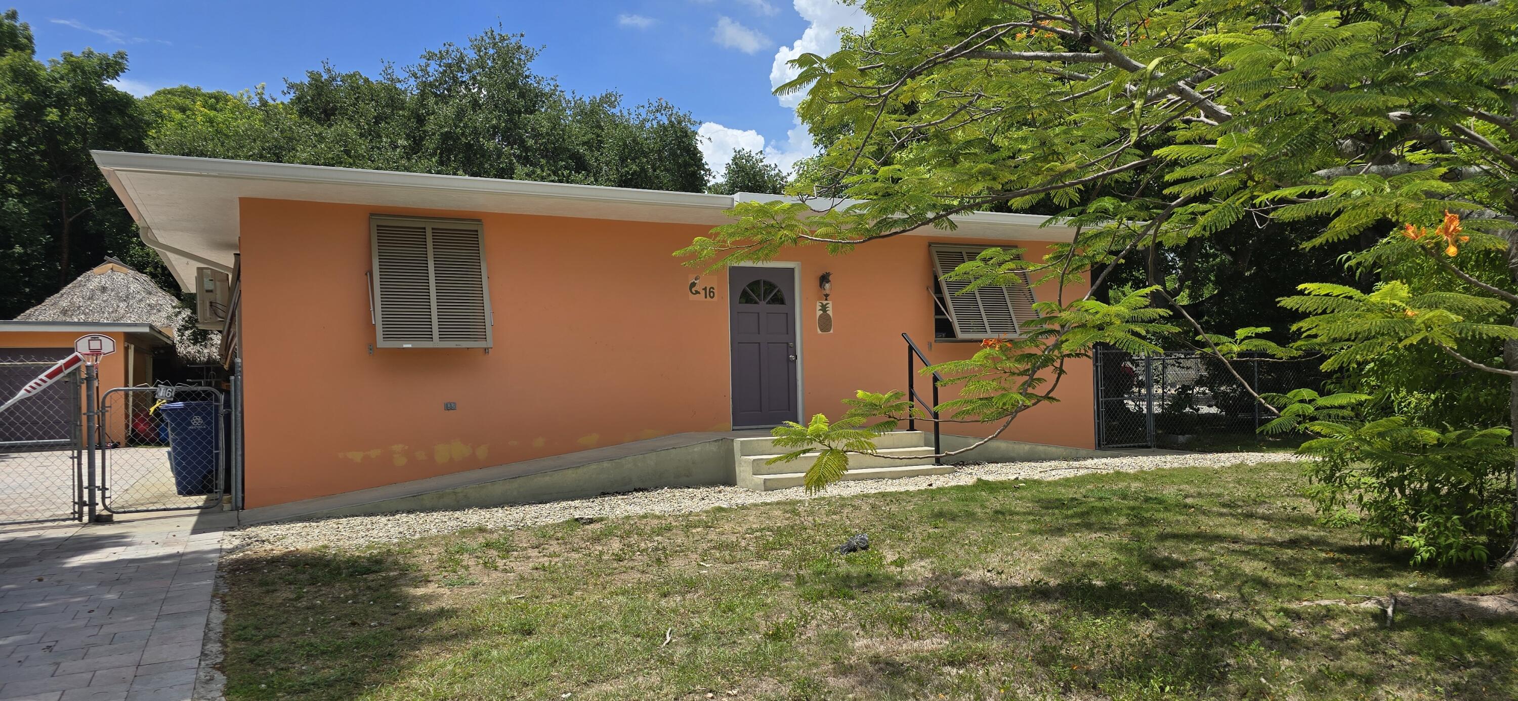 a backyard of a house with table and chairs