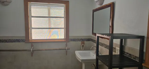 a kitchen with a sink window and cabinets