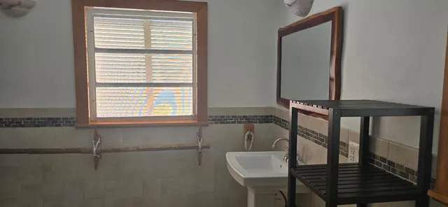 a kitchen with a sink window and cabinets