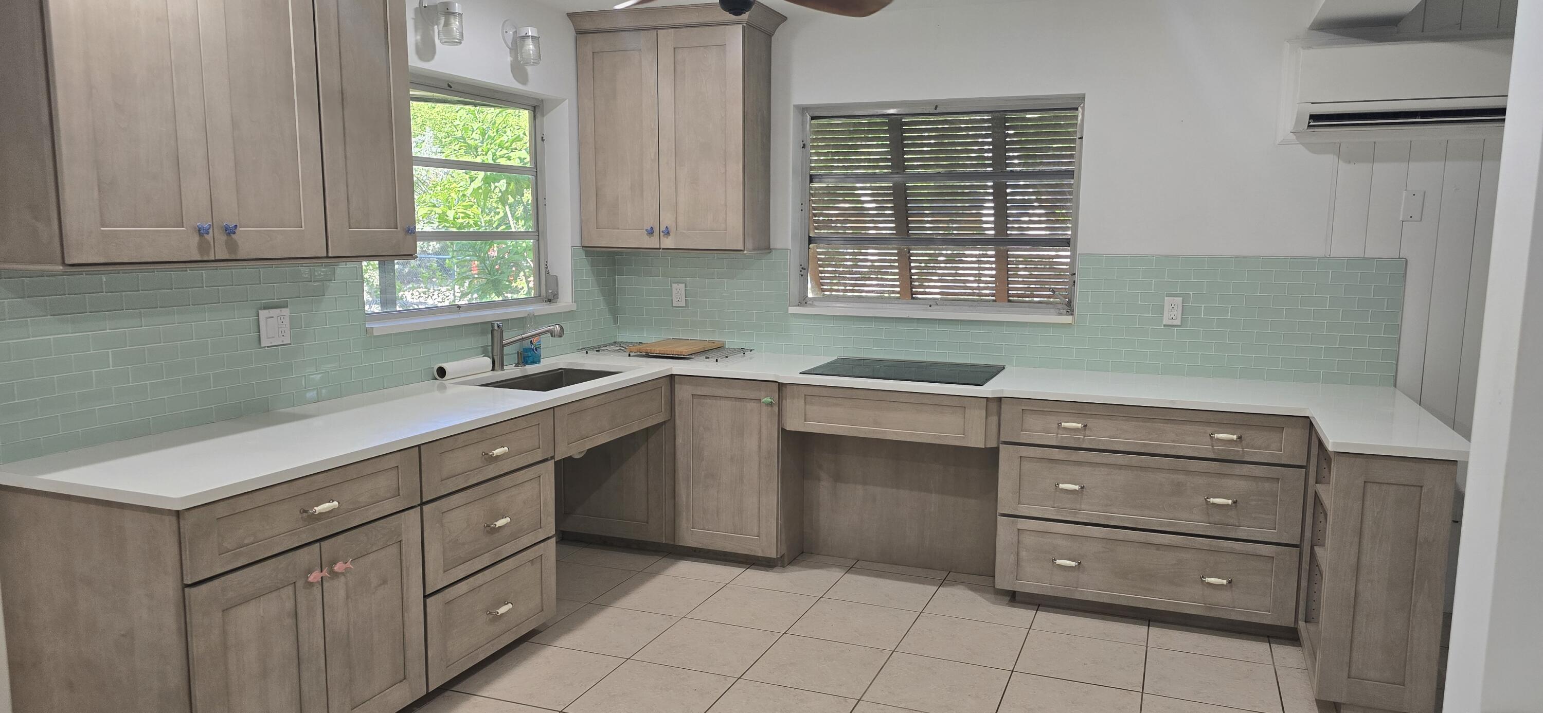 16 Pompano Avenue Key Largo, FL 33037 - Photo 17 of 23 a kitchen with a sink window and cabinets