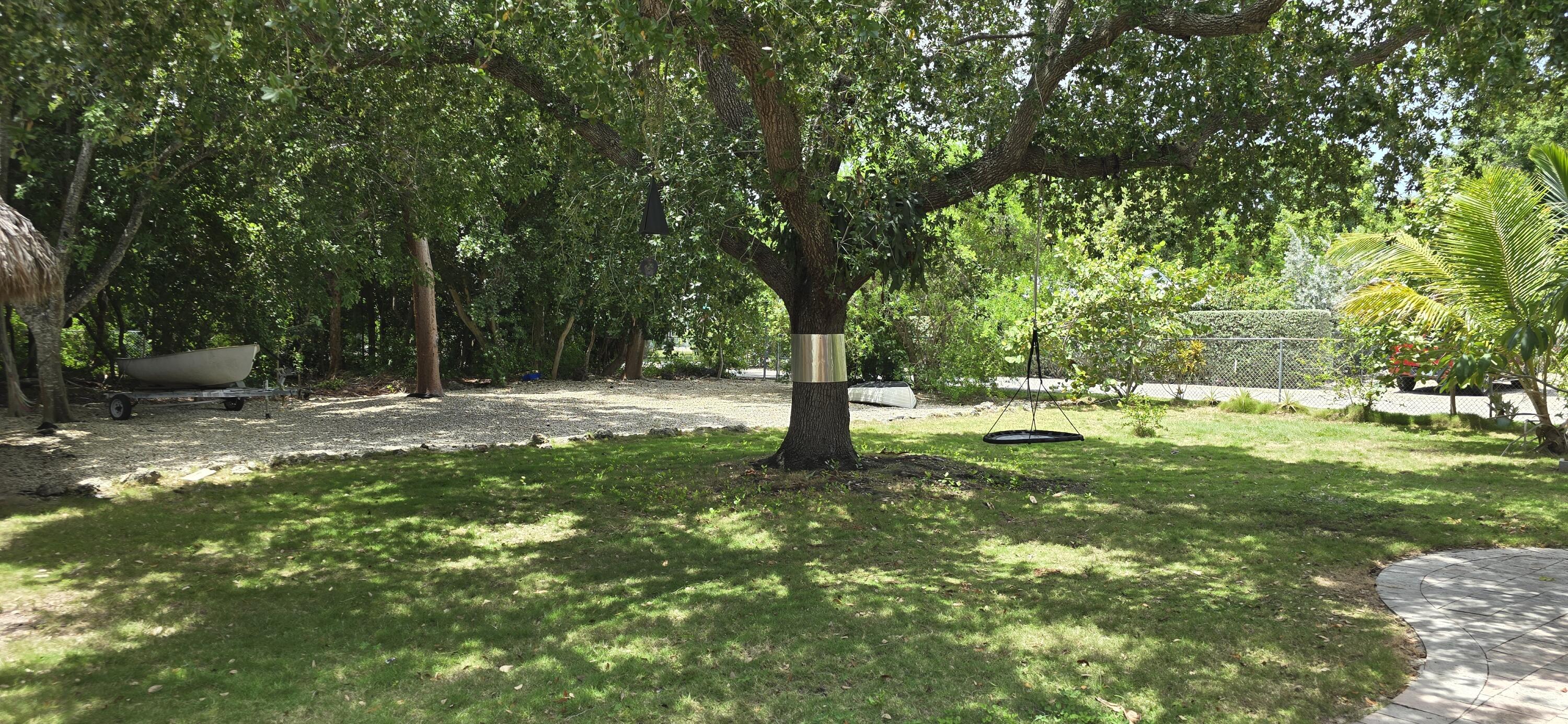 16 Pompano Avenue Key Largo, FL 33037 - Photo 2 of 23 a backyard of a house with lots of green space