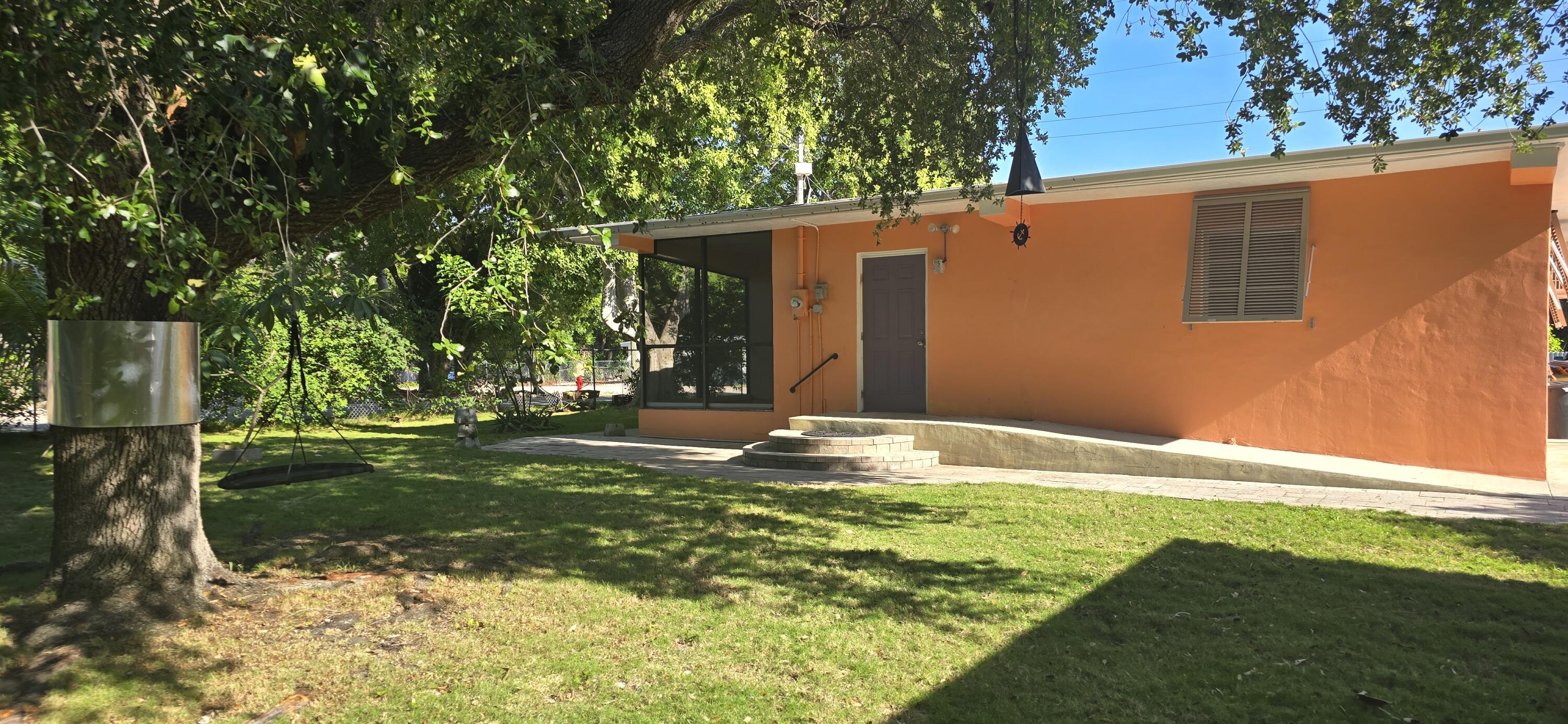16 Pompano Avenue Key Largo, FL 33037 - Photo 9 of 23 a backyard of a house with lots of green space