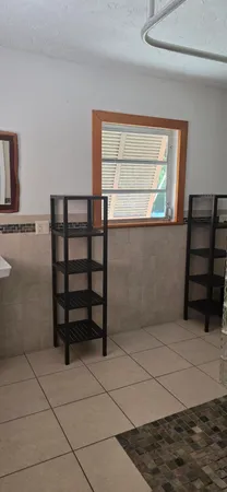 a view of a room with rack on the wall and a window