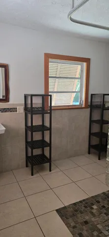 a view of a room with rack on the wall and a window